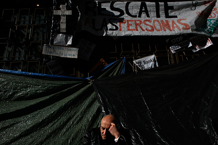 24 hours: A protester sits outside the headquarters of Bankia 