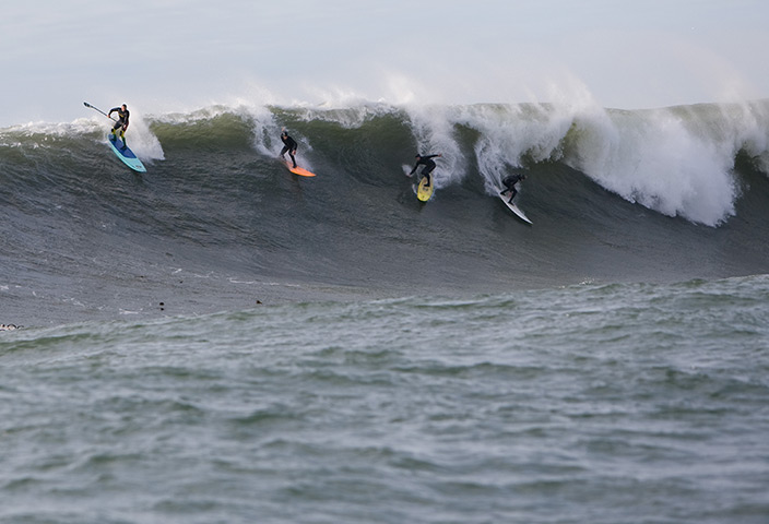 Garrett McNamara : 2008: McNamara (left) on a stand up paddle board