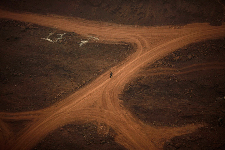 24 hours in pictures: A man walks along an empty construction site in downtown Chongqing