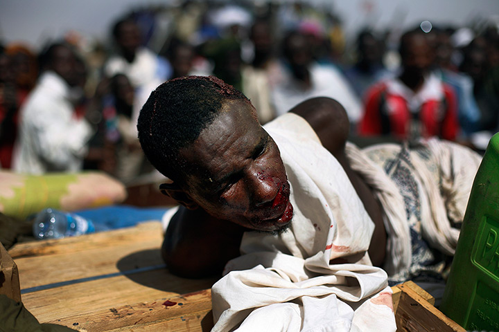 24 hours in pictures: A suspected Islamist lies in the back of an army truck
