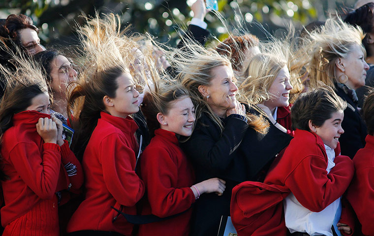 A lighter look: Students watch Marine one carrying Obama 