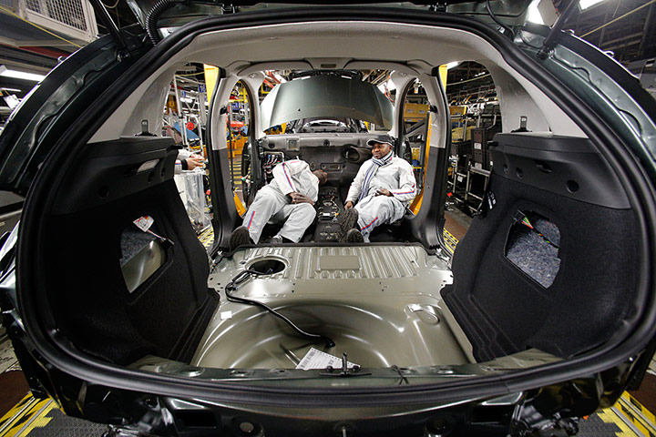 A lighter look: Workers take a break in a car at the PSA car plant