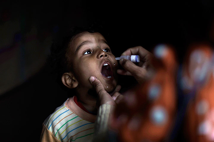 24 Hours: Islamabad, Pakistan: A health worker gives a polio vaccine to a child