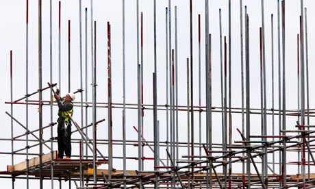 A scaffolder at work on a building site, construction site with scaffolding