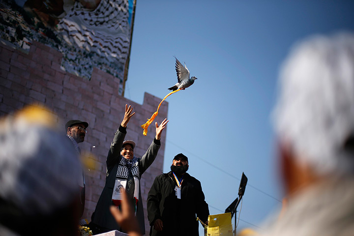 24 hours in pictures: Palestinian releases a pigeon during a rally in Gaza