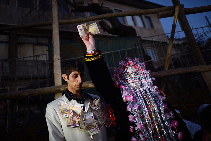 24 hours in pictures: Fatme Ulanova shows to the crowd euro banknotes as wedding presents