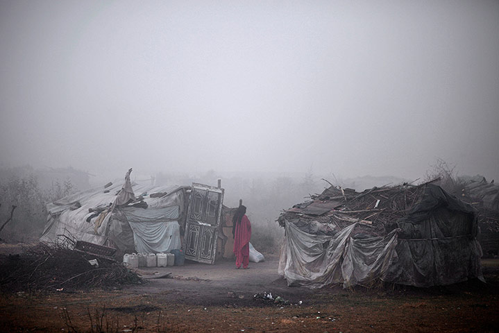 20 Photos: A woman stands outside her makeshift home in Islamabad