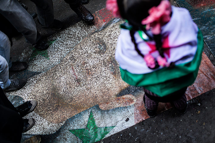 24 Hours: People stomp on a portrait of President Bashar al-Assad in Aleppo