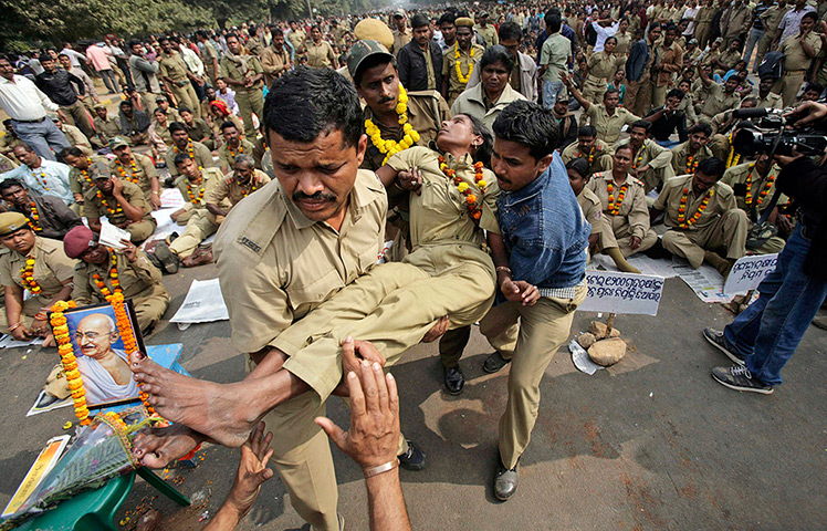 24 hours: Bhubaneswar, India: Orissa state home guards carry an unconscious colleague
