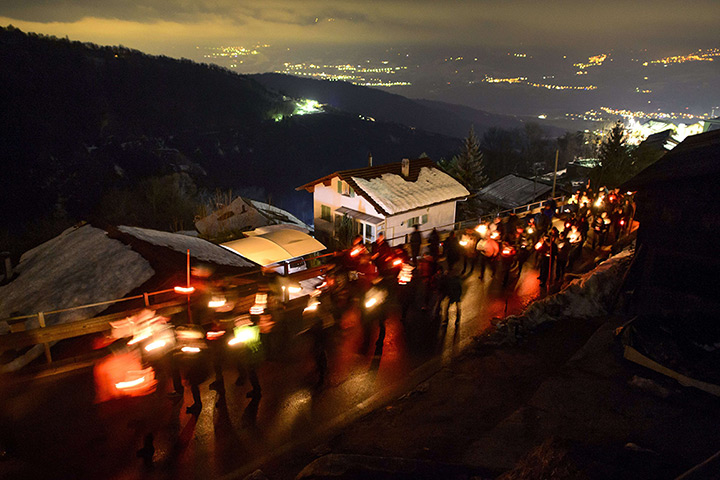 24 hours: Daillon, Switzerland: People walk in memory of shooting victims