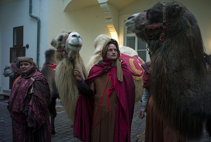Epiphany Day: A man holds a camel before a traditional march in Prague