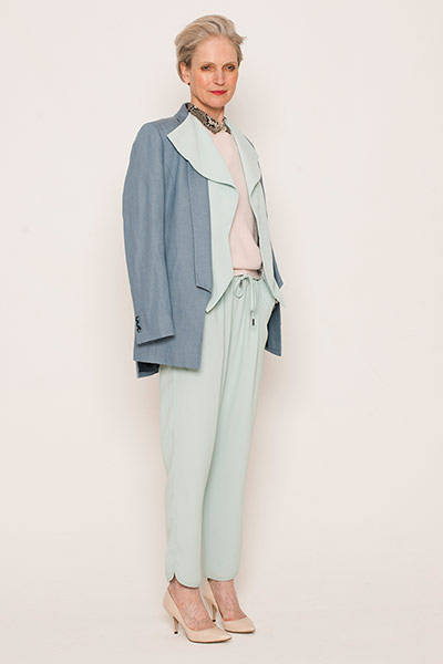 All Ages - Pastels: Lisskulla wears blue-grey blazer. Pale green trousers, blazer. Pink jumper