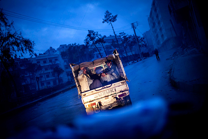 24 hours: Aleppo, Syria: Syrian men leave the old city in the back of a truck