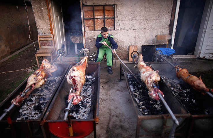 24 hours: Vojkovici, Bosnia and Herzegovina: A Bosnian Serb boy roasts