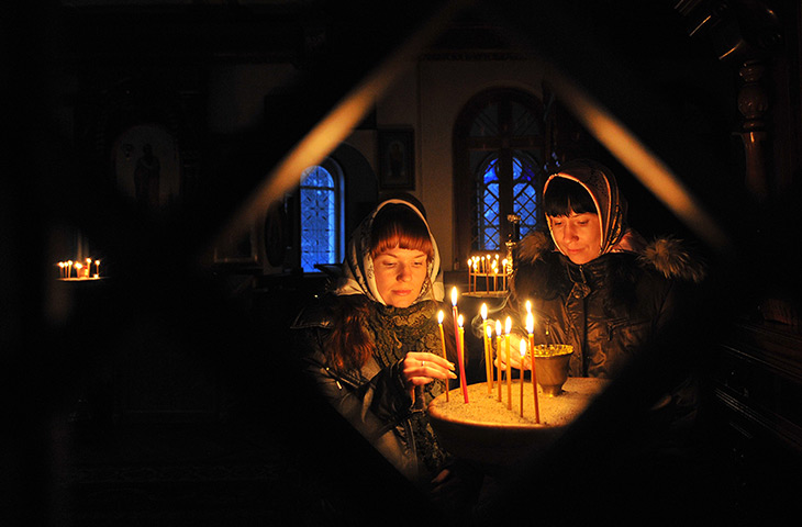 24 hours: Sokuluk, Kyrgyzstan: Sisters light candles during Orthodox Christmas