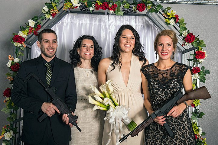 Shotgun weddings: Members of the wedding party pose for photos with the bride and weaponry