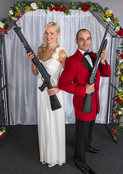 Shotgun weddings: A couple poses for a photograph with guns
