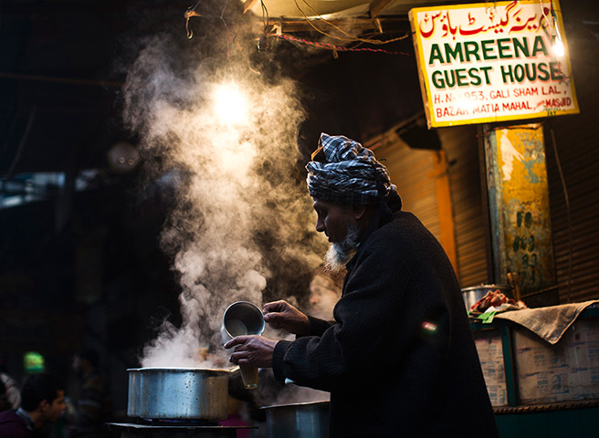 Cold weather in India: A vendor prepares tea at his roadside tea stall