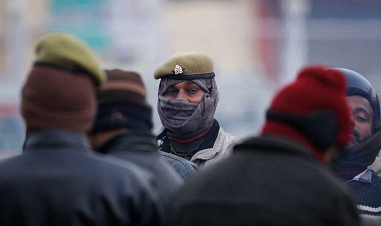 Cold weather in India: Policemen, wrapped up against the cold, stand guard at the Sangam
