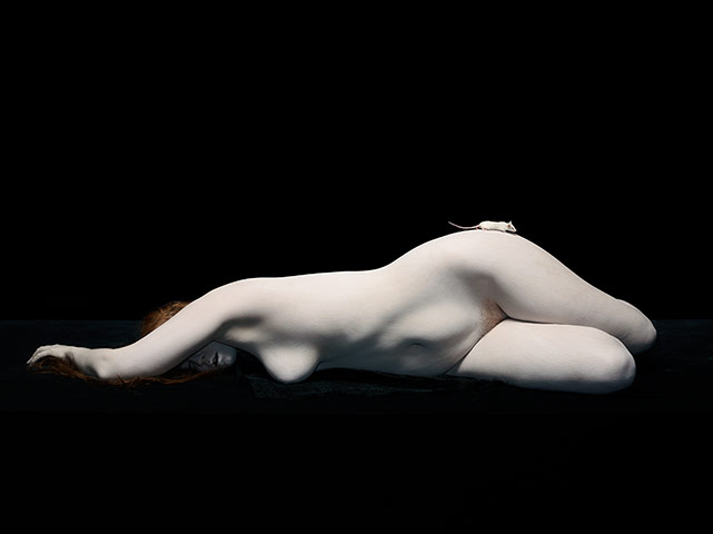 Nadav Kander: Isley lying with white mouse on hip, 2012