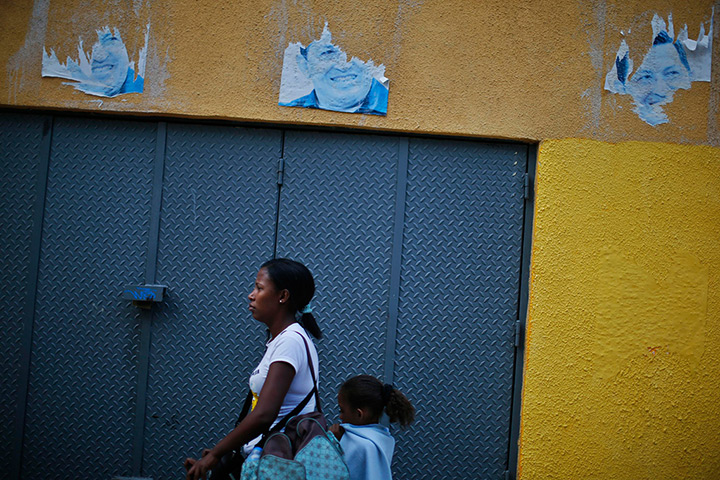 24 hours: Caracas, Venezuela: A woman and a child walk past remains 