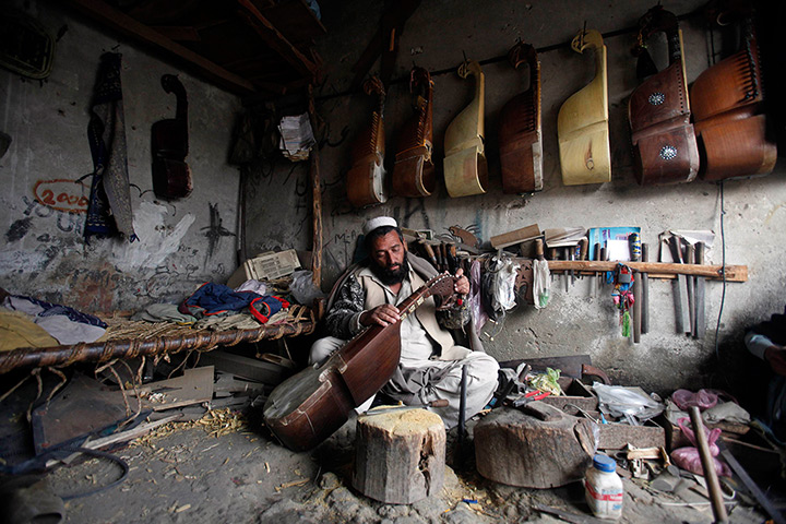24 hours: Peshawar, Pakistan: A man repairs a rabab