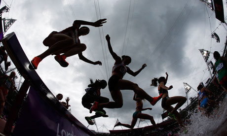 athletes jumping over puddles