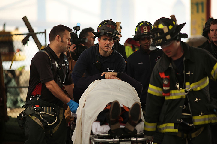Seastreak ferry: n injured person is carried to a waiting ambulance