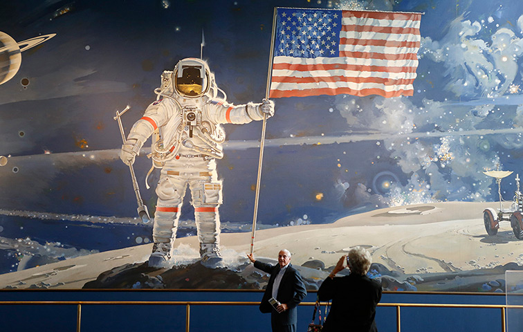US shutdown: A man pretends to hold the US flag as his picture is taken at Smithsonian Air and Space Museum