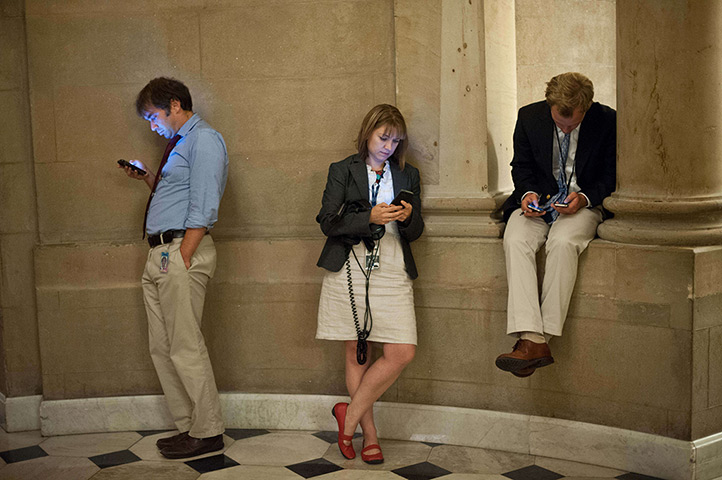 Reporters wait outside the office of US House Speaker John Boehner