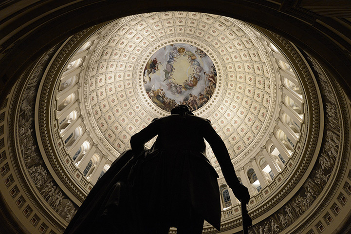 US shutdown: The Capitol rotunda behind the silhouette of a sculpture of George Washington