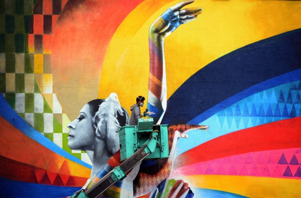 No need to wonder why this picture stood out from the crowd. An artist puts the final touches to a huge mural on a building in central Moscow. Wow!