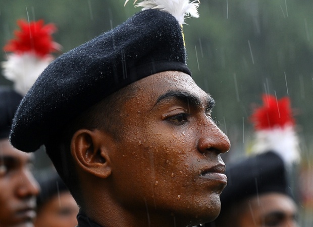 A study of poise: a Sri Lankan soldier stands to attention in the rain during the army's 64th anniversary and Army Day ceremony in Colombo.