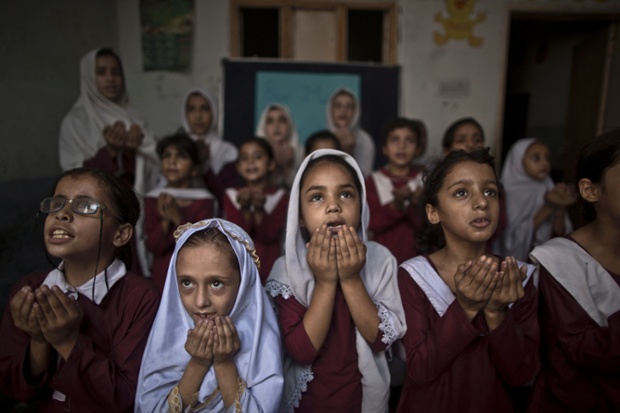 A poignant photograph of children offering prayers during a special class at a school in Rawalpindi, Pakistan, marking the anniversary of the shooting of Malala Yousafzai. One year after the Taliban used a bullet to try to silence Malala's demand for education, she has published a book and is a contender for the Nobel peace prize.