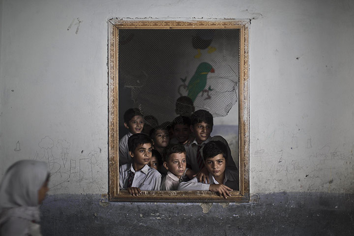 20 Photos: Schoolboys look out the window of their classroom in Rawalpindi, Pakistan