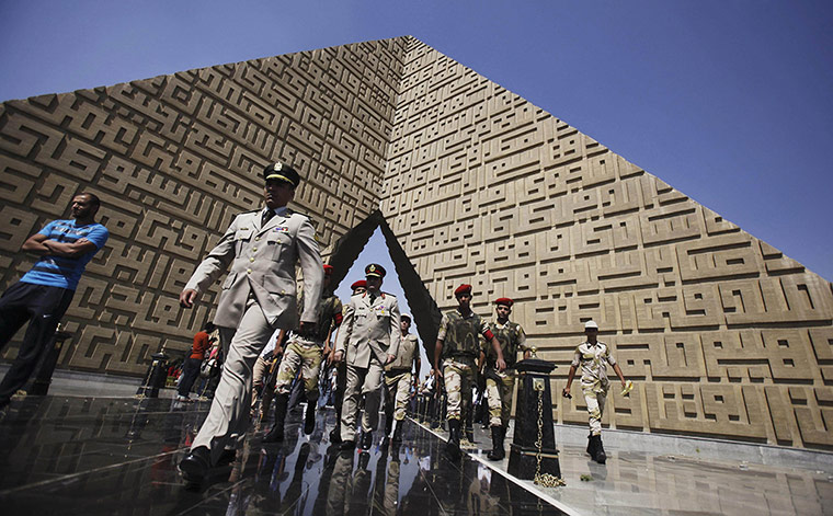 20 Photos: Members of the army walk at the tomb of late President Sadat in Cairo