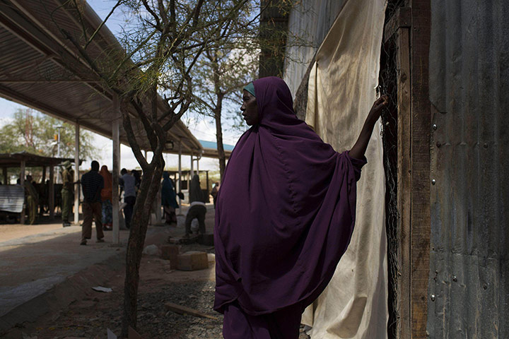 20 Photos: A woman waits her turn to collect her ration of food in Dadaab, Kenya