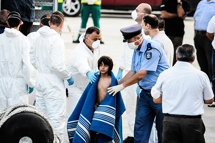 Malta: Children are carried to safety by police and officers of the Maltese armed forces