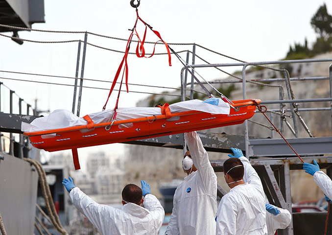 Malta: The body of a drowned migrant is lowered from a ship 