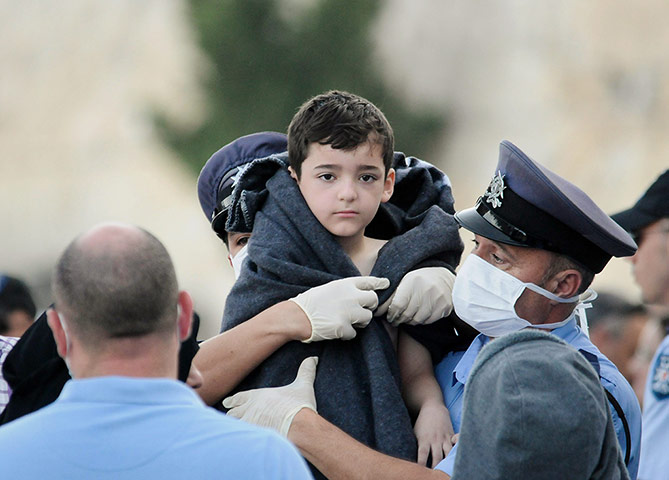 20 Photos: A child is carried to safety by police in Valletta, Malta