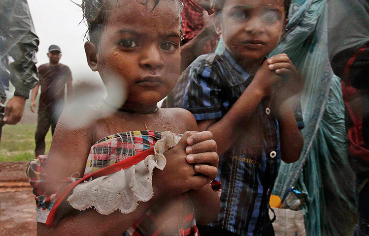 Cyclone: Indian villagers are brought to a relief camp