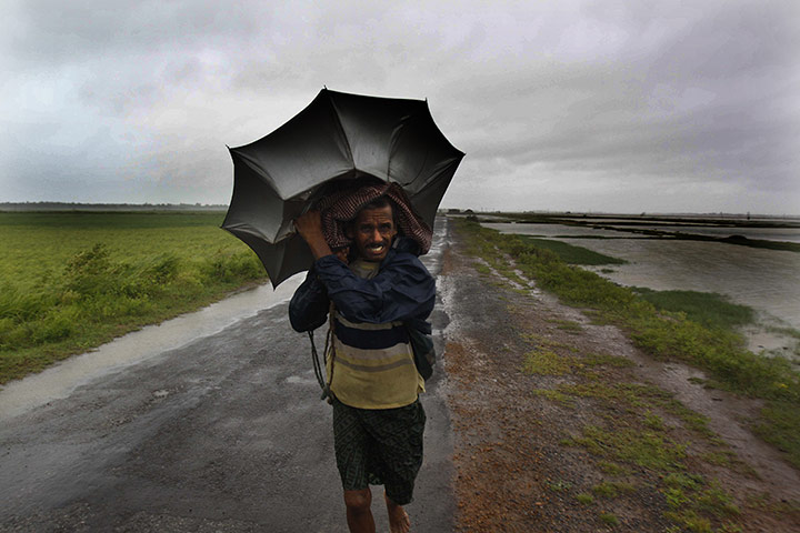 Cyclone: An Indian villager braving strong winds