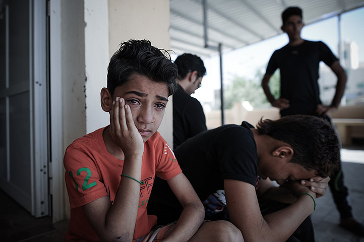 Weekend in pictures: Manama, Bahrain: A boy mourns during the funeral of Yussef al-Nashmi, who d
