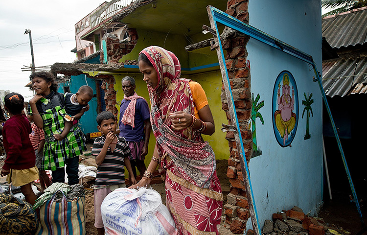 Cyclone Phailin damage: A woman waits with her family to return to Sonepur village after cyclone Ph