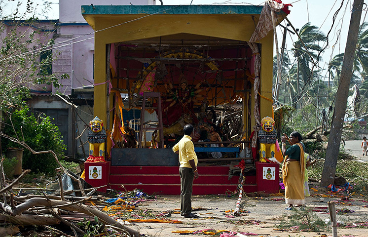 Cyclone Phailin damage: A man looks at a damaged pandal - a place of worship - in Gopalpur