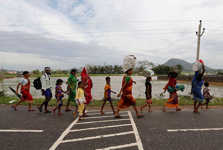 Cyclone Phailin damage: Villagers return to their villages after Cyclone Phailin hit Girisola town 