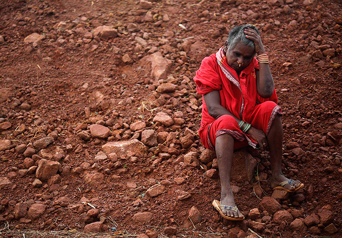 Cyclone Phailin damage: A woman waits to board a boat to return to her village in the eastern India