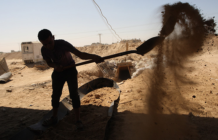 Gaza tunnels: A Palestinian youth works outside a smuggling tunnel 