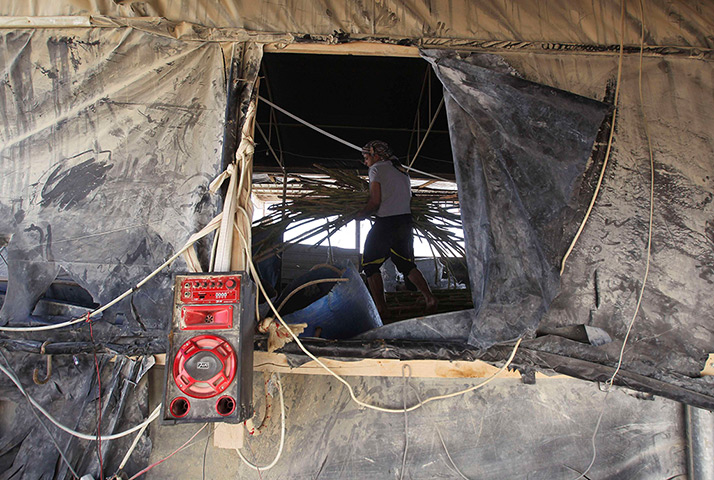 Gaza tunnels: A tunnel worker carries wood as he repairs a tunnel 