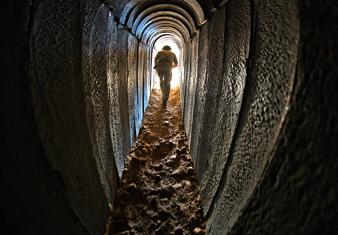 Gaza tunnels: An Israeli soldier walks out from a tunnel during a tour of the tunnel that